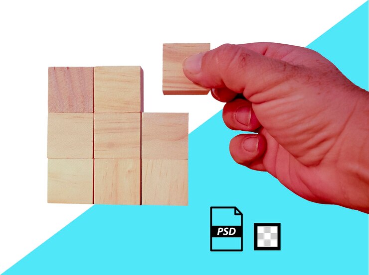 PSD closeup of a persons hand placing several wooden cubes on a transparent background