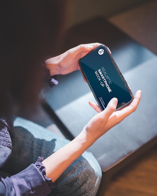 Closeup of woman using smartphone in cafe.