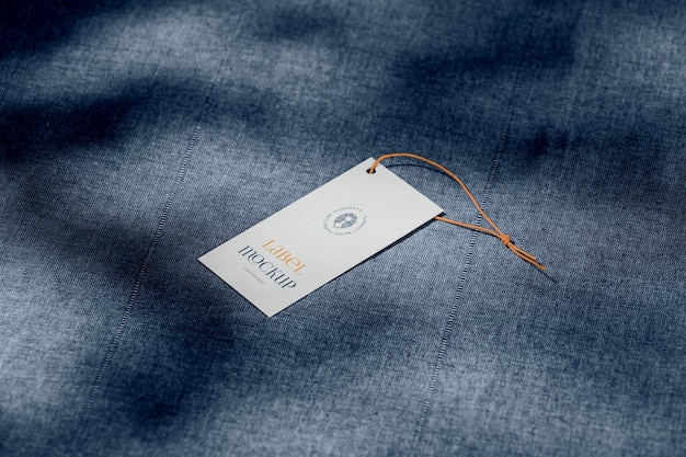 PSD clothing label mockup on a denim background with changeable background color