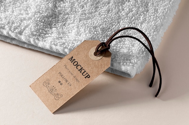 PSD clothing mock-up tag with thread on towel