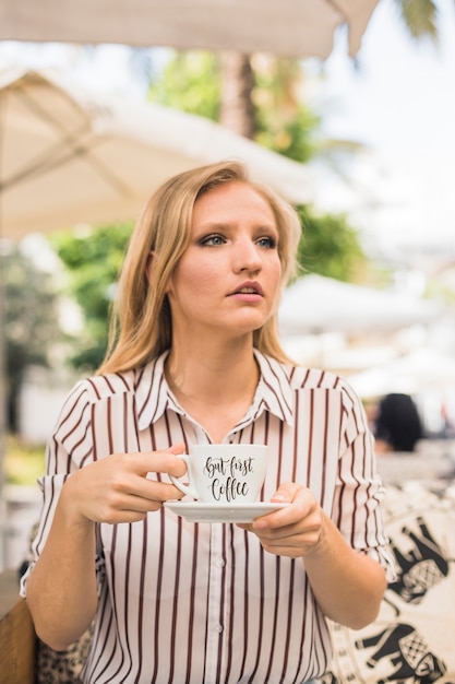 PSD coffee cup mockup with woman