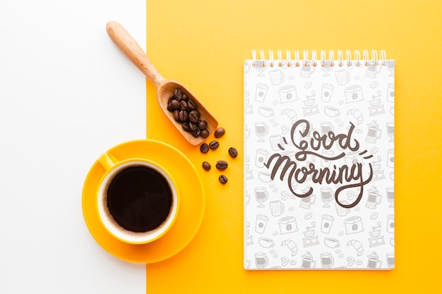 PSD coffee cup next to a notebook mock-up