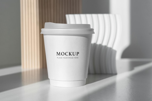 PSD coffee paper cup mockup on table