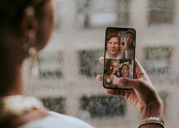 Colleagues having a video conference on a mobile phone mockup during the coronavirus pandemic