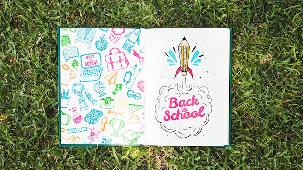 colorful book on grass mock-up