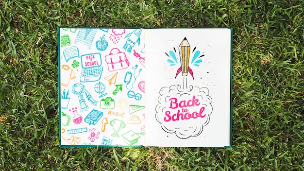 PSD colorful book on grass mock-up