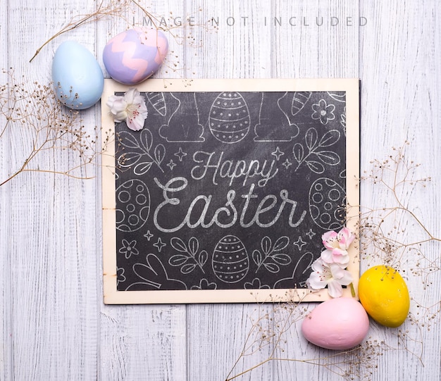 Colorful easter eggs with flowers on wooden surface. A chalk board mockup