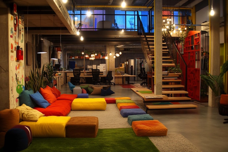 PSD colorful modern openplan workspace with comfy seating stylish decor and loft area