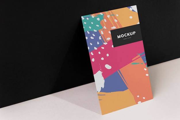 Colorful paperboard mockup against the black wall