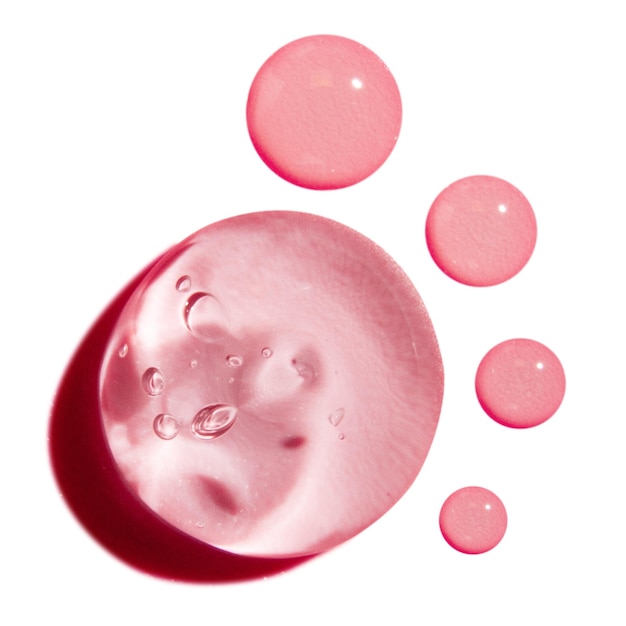 composition of transparent pink gel and drops on empty background