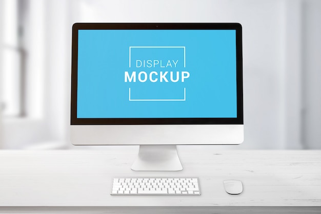 Computer display on office work desk mockup.