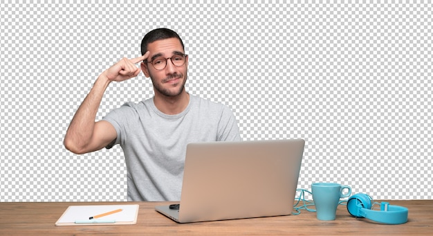 PSD concerned young man sitting at his desk with a gesture of concentration