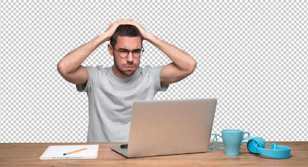 Concerned young man sitting at his desk