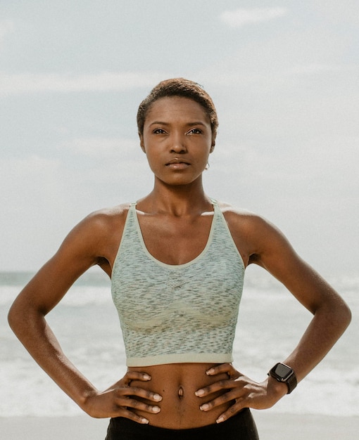 PSD confident sporty black woman on the beach