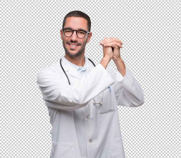 Confident young doctor doing a gesture of unity