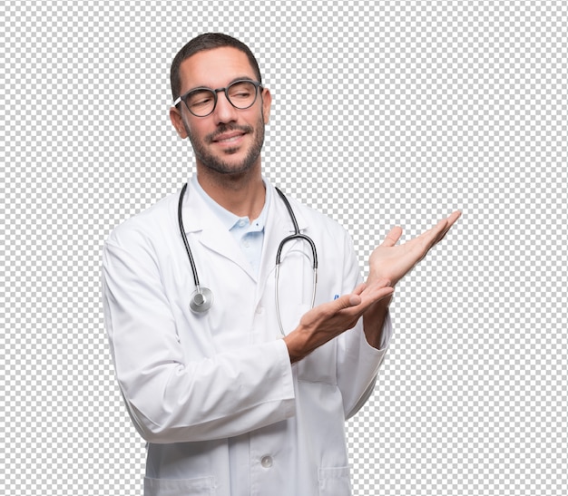 Confident young doctor showing something with his hands