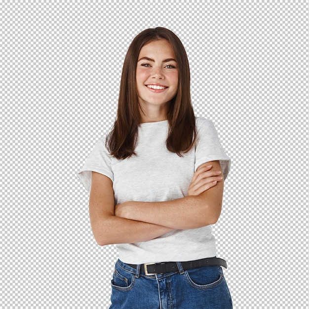 Confident young female student standing with crossed arms and smiling at front posing over white wall