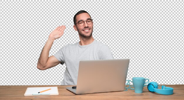 PSD confident young man sitting at his desk and doing a gesture of welcome