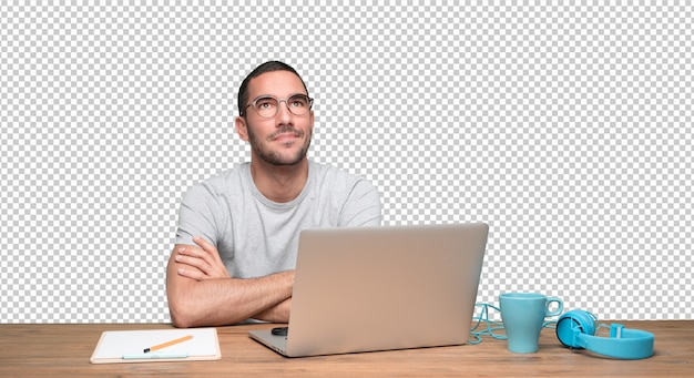 PSD confident young man sitting at his desk and looking up