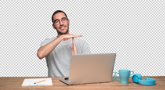 PSD confident young man sitting at his desk with a gesture of pause