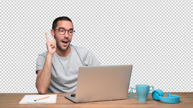 Confident young man with a gesture of doubt sitting at his desk