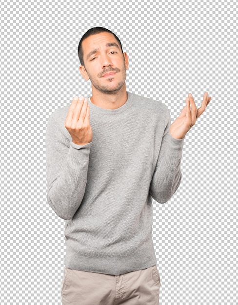 Confused young man making an italian gesture of not understand