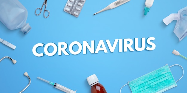 PSD Текст coronavirus на голубом столе окруженном медицинским оборудованием и лекарствами. photoshop psd создатель сцены с разделенными слоями