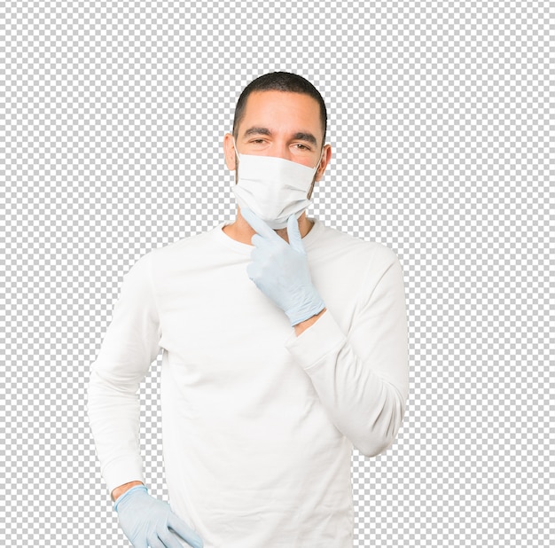 コロナウイルスの概念をやって、マスクと保護手袋を着用して若い男