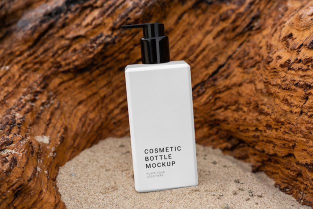 PSD a cosmetic bottle mockup sits in the sand