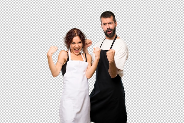 couple of cooks celebrating a victory and happy for having won a prize