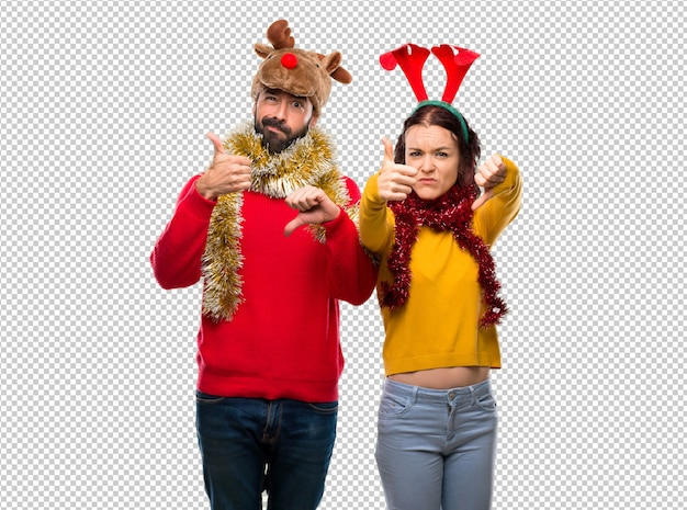 PSD couple dressed up for the christmas holidays making good-bad sign. undecided between yes or not