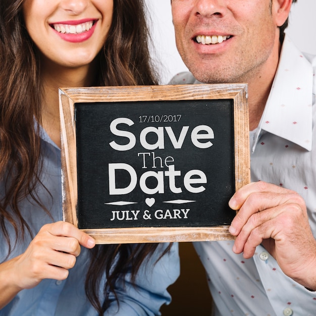 Couple holding slate