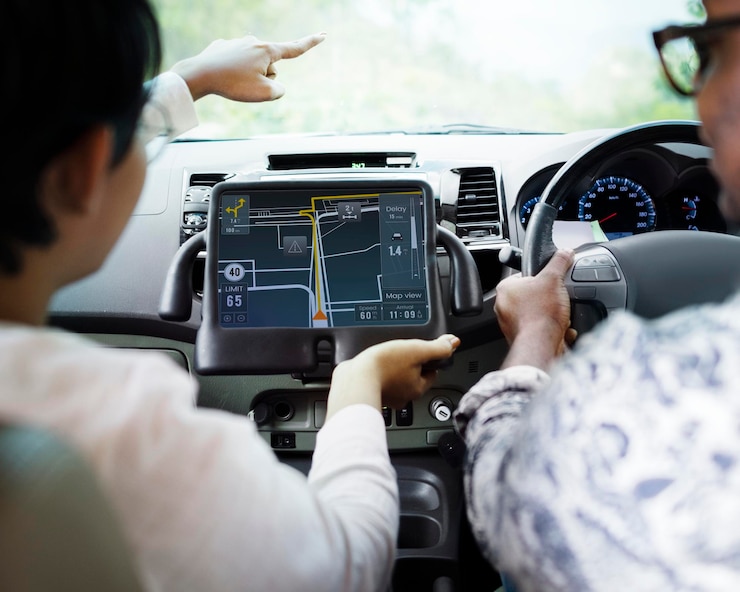 PSD couple in a car finding direction on a tablet with gps