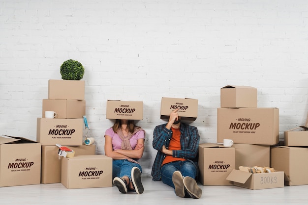 Couple posing silly with moving boxes over their heads