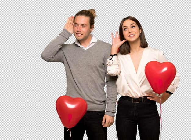 PSD couple in valentine day listening to something by putting hand on the ear