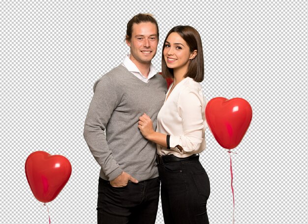 Couple in valentine day posing with arms at hip and smiling