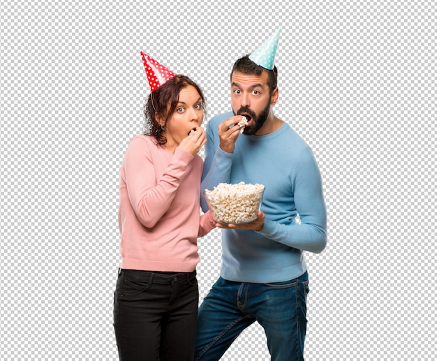PSD couple with birthday hats and eating popcorns