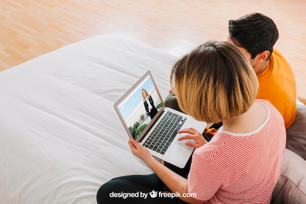 PSD couple with laptop in bed