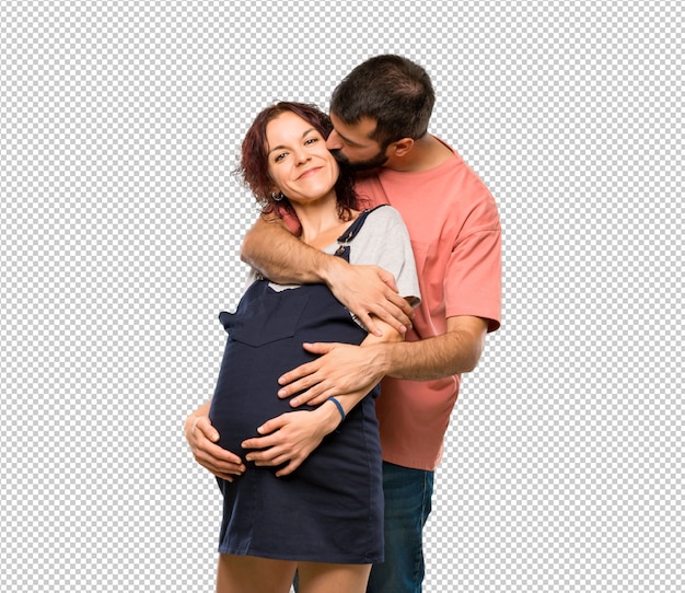 Couple with pregnant woman hugging