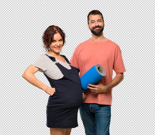 Couple with pregnant woman with mat