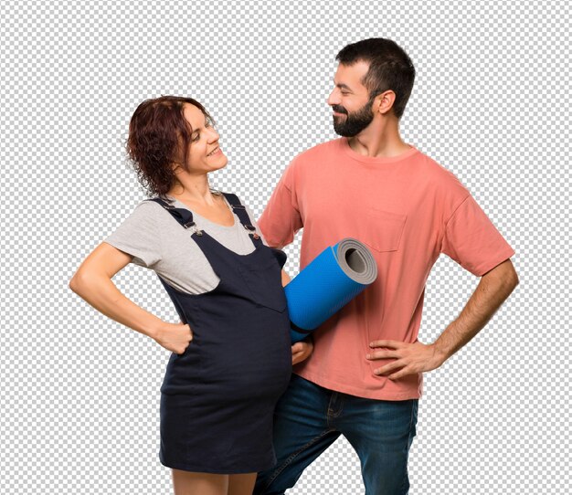 Couple with pregnant woman with mat