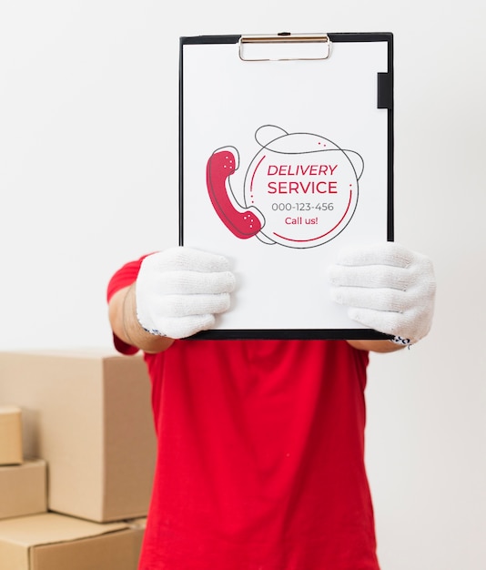 PSD courier holding clipboard near parcels mock-up