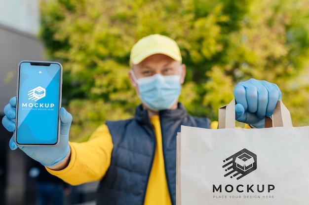 Courier holding phone and bag mockup