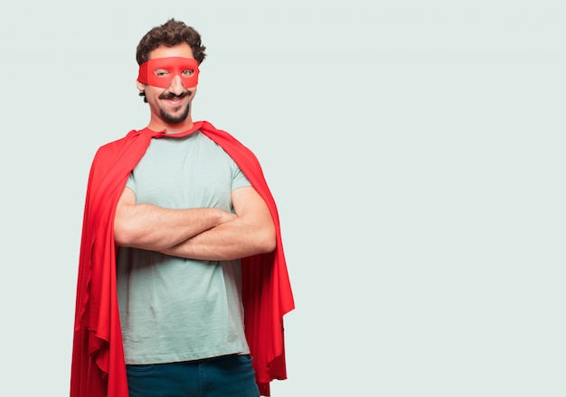 crazy man as a super hero with a proud, satisfied and happy look on face, smiling with arms crossed