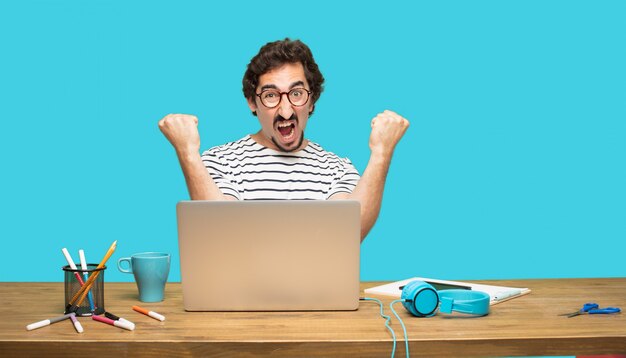 crazy man with laptop celebrating