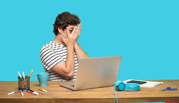 Crazy man with laptop in sad pose