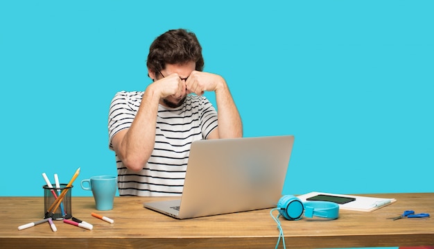 crazy man with laptop in sad pose