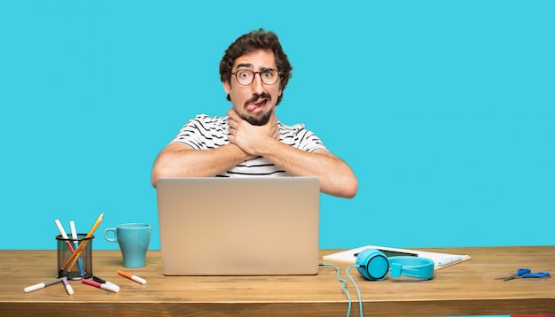 Crazy man with laptop with fearful expression