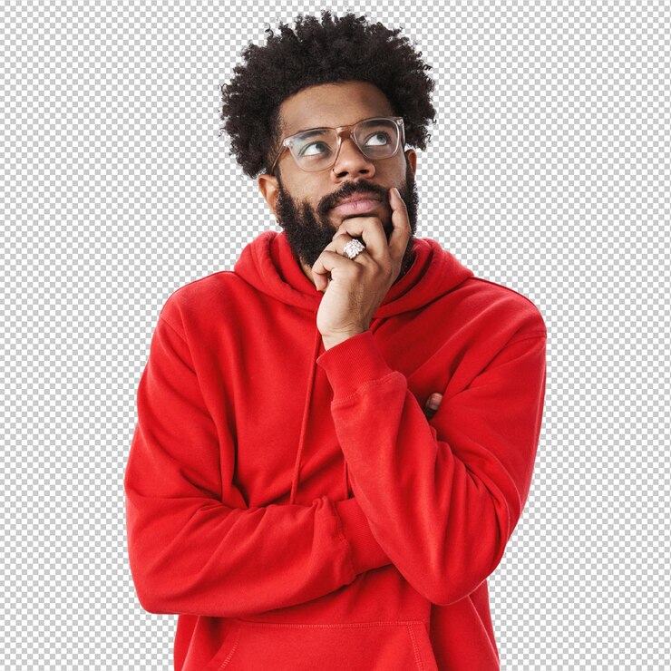 PSD creative african american bearded guy with afro hairstyle in glasses and red hoodie creating new song standing in thoughtful pose touching chin looking dreamy focused at upper right corner thinking