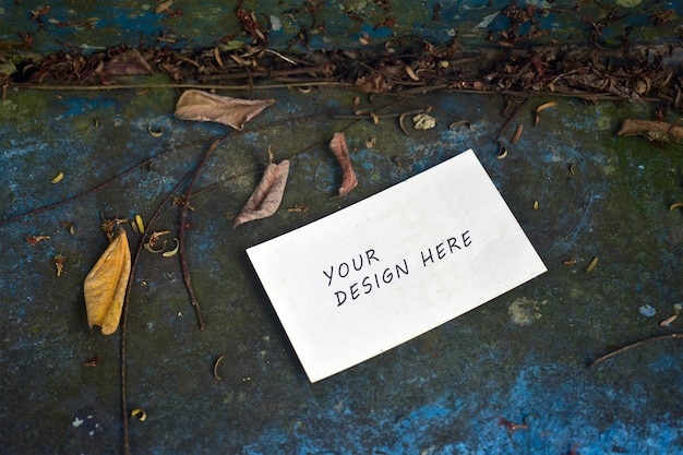 Creative business card mockup on autumn floor